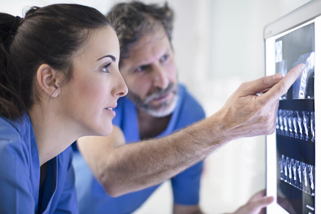 Two dentists examining an x-ray